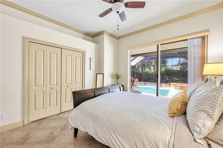 Bedroom with crown molding, access to exterior, a ceiling fan, a sunroom, and a closet