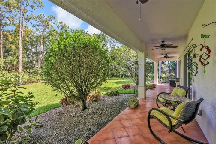 Porch featuring a ceiling fan and a yard