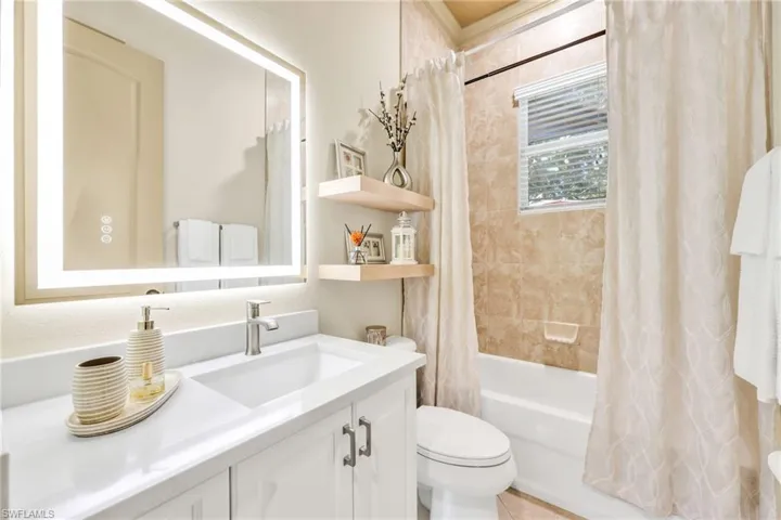 Bathroom featuring vanity and shower / tub combo