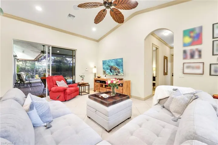 Living area with crown molding, ceiling fan, tile patterned floors, a sunroom, and recessed lighting