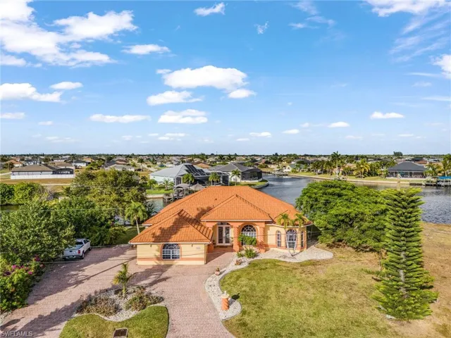 Aerial view of residential area featuring a nearby body of water