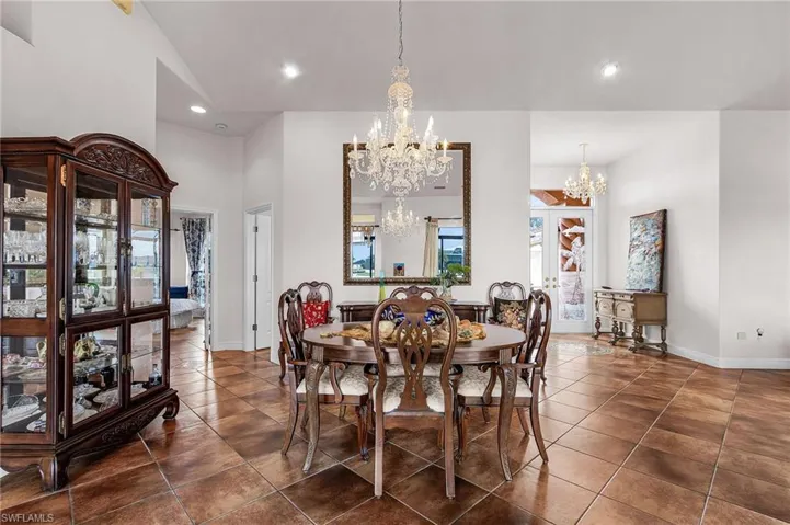 Dining space featuring recessed lighting and dark tile patterned flooring