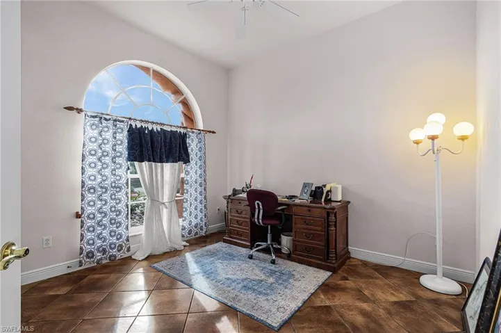 Office featuring healthy amount of natural light and dark tile patterned flooring