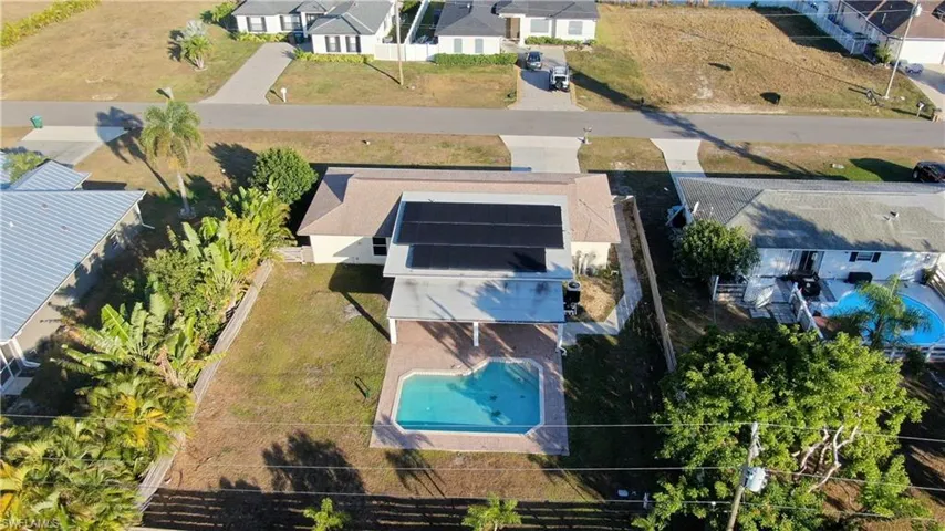 Aerial perspective of suburban area with a pool area