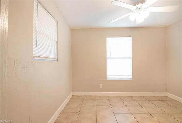 Spare room with light tile patterned floors and ceiling fan