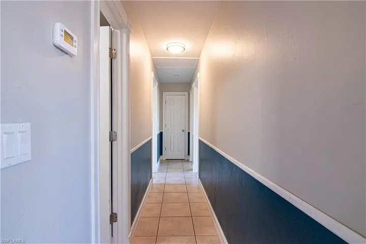 Corridor featuring light tile patterned floors