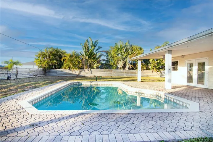 View of pool featuring a patio area, french doors, and a fenced backyard