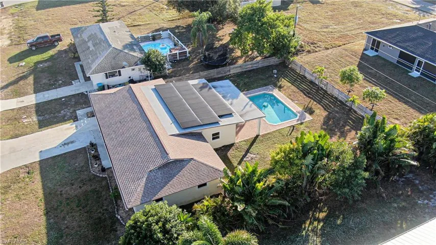 Aerial view of property and surrounding area with a pool area