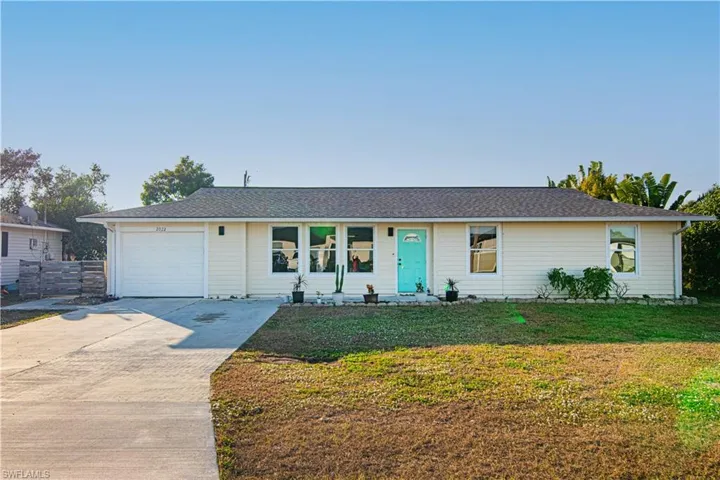 Ranch-style home with driveway, an attached garage, and a shingled roof