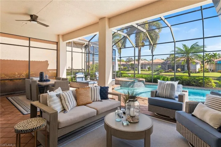 A backyard oasis includes multiple seating areas & inground pool with spa
