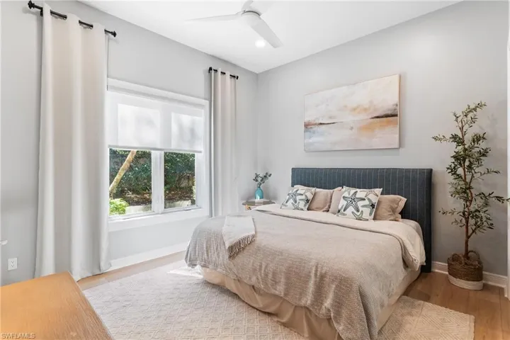 Bedroom with ceiling fan and wood-type flooring