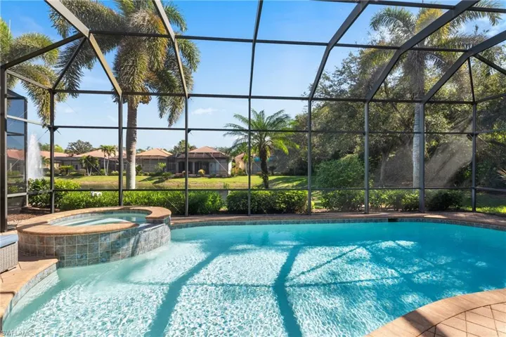 View of pool overlooking  lake with fountain