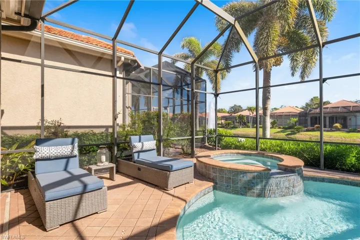 View of swimming pool featuring an in ground hot tub