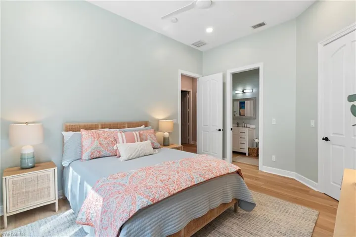 En-Suite bedroom with ceiling fan & custom blinds and drapery