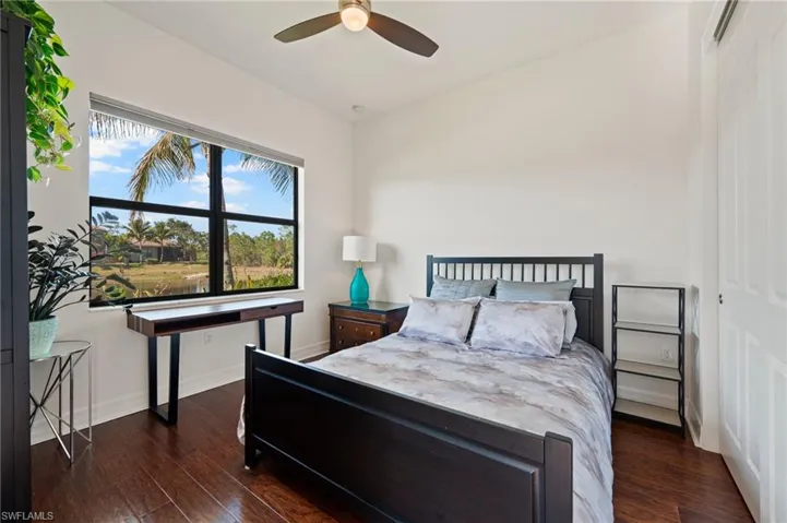 Bedroom featuring dark hardwood / wood-style flooring and ceiling fan