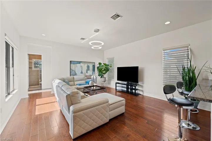Living room with hardwood / wood-style flooring