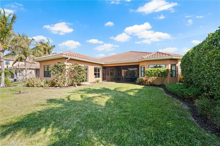 Back of property featuring a yard and a sunroom