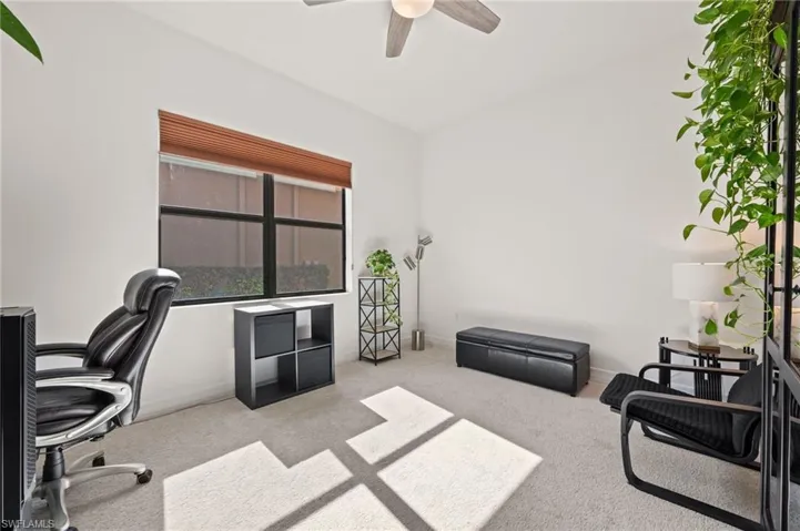 Carpeted office space with ceiling fan