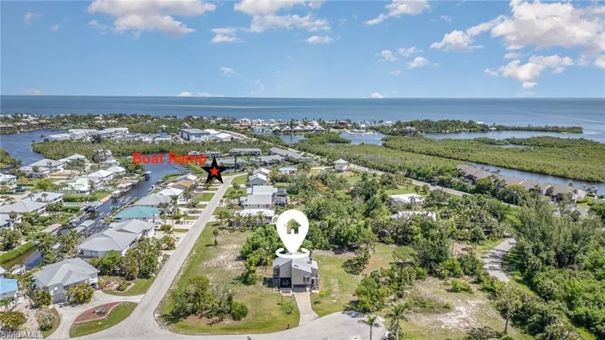 Aerial perspective of suburban area featuring a large body of water