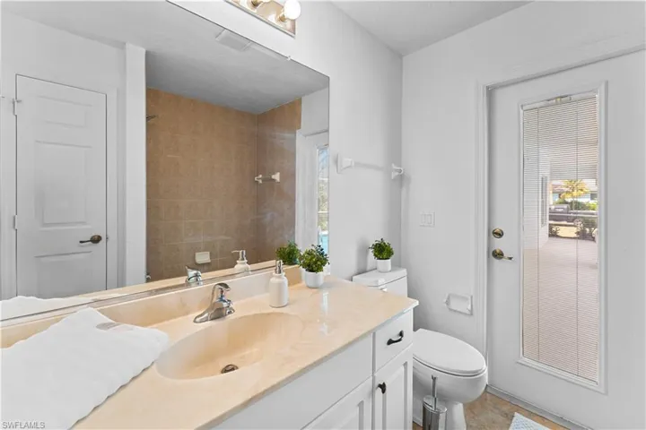 Full bathroom with vanity and a tile shower