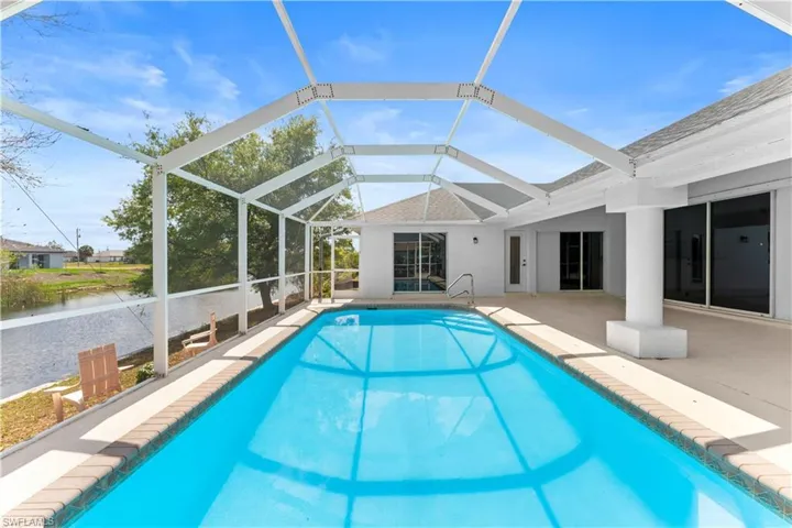 Outdoor pool with a sunroom, a lanai, and a patio