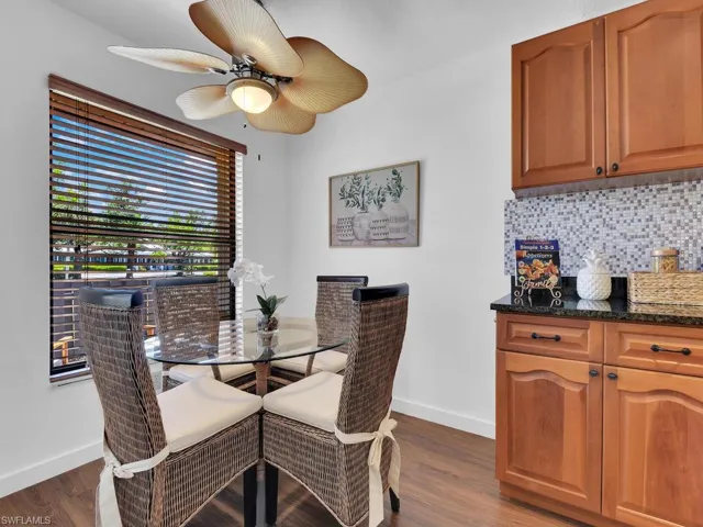 Dining space with ceiling fan and dark hardwood / wood-style flooring