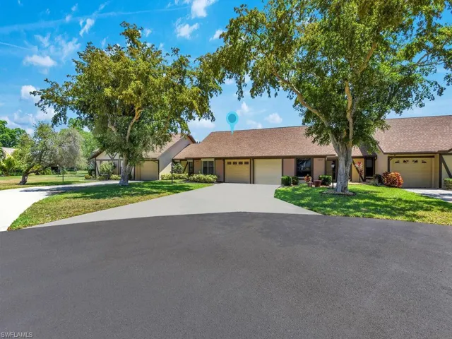 Ranch-style home featuring a garage and a front yard