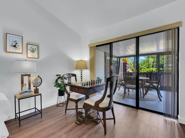 Dining area with hardwood / wood-style flooring and lofted ceiling