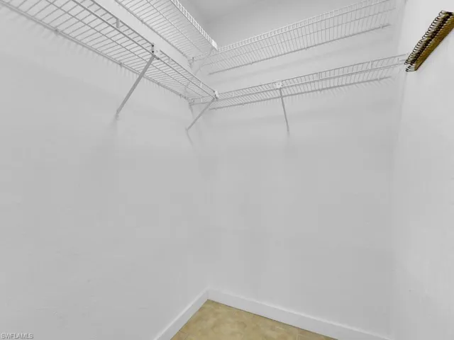 Spacious closet featuring tile floors