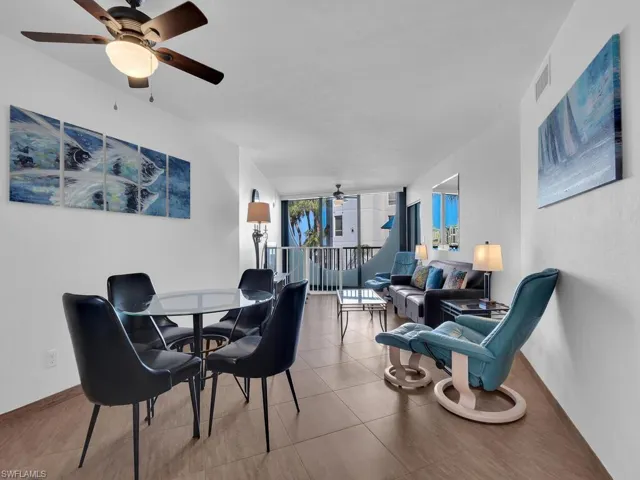 Tiled dining/family room with floor to ceiling windows