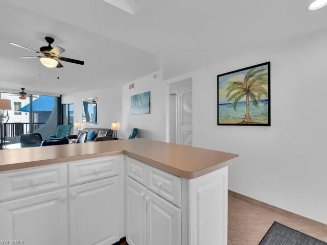 Kitchen with kitchen peninsula, white cabinets