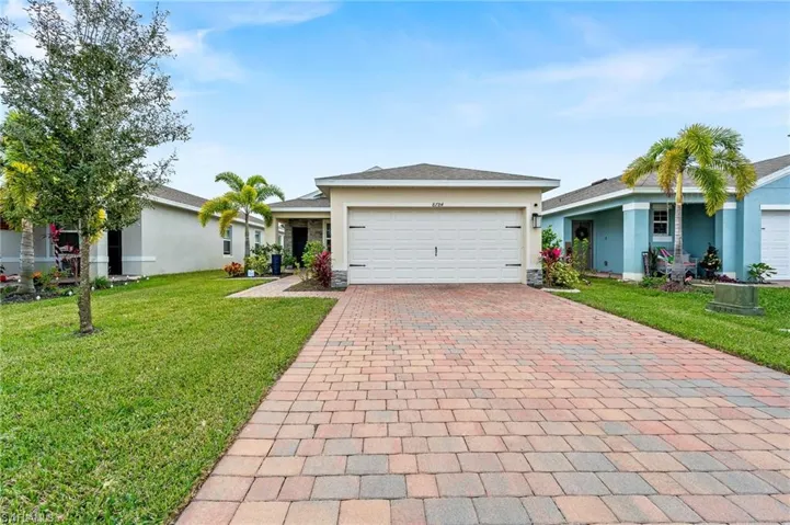 Paver drive, 2 car garage, professionally landscaped + so much more!