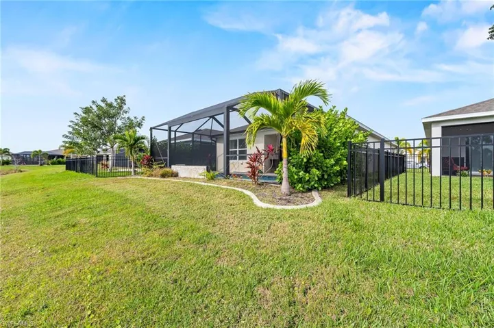 Backyard is completely landscaped giving you privacy with large bushes on each side. The landscaping also has professional concrete edging all around.