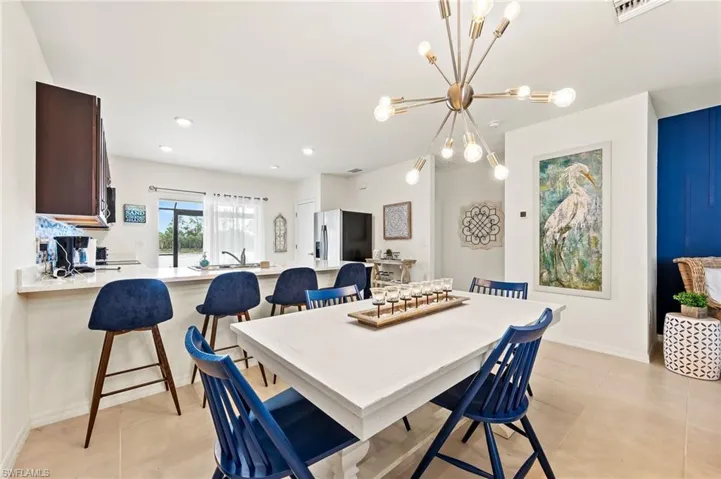 Kitchen features a big seating area for any size table + a breakfast bar big enough for 4-6 chairs. Also note the gorgeous DR light
