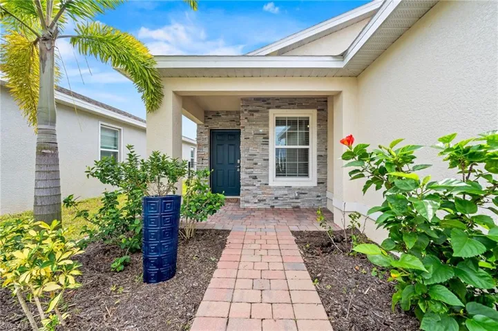 This house shines inside and out. The owner has added this beautiful stone work on the front as well as concrete curbed edging all around the landscaping front and back of the home