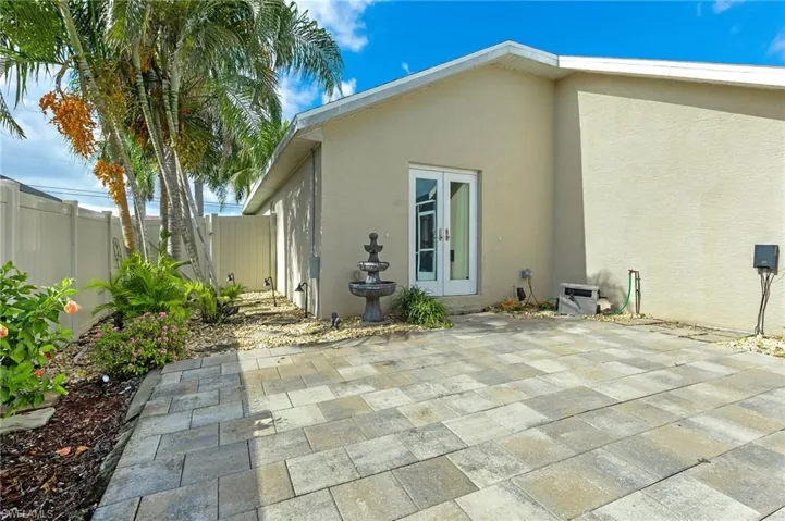 Rear view of house with french doors and stucco siding