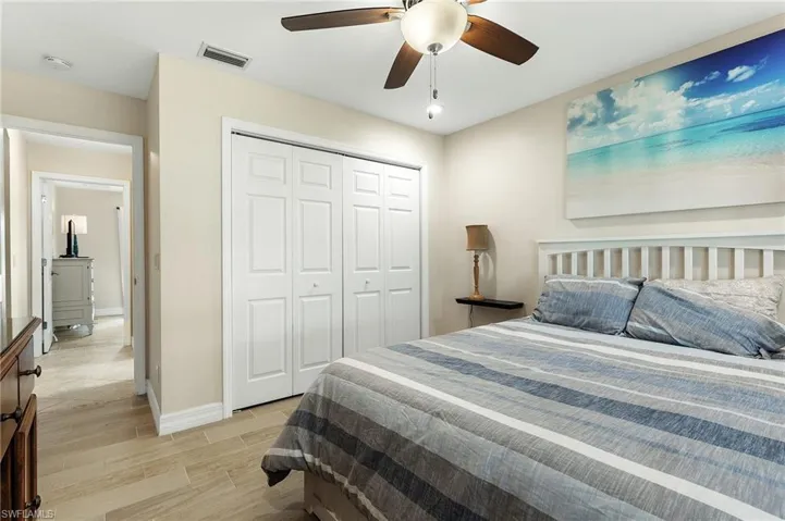 Bedroom with wood finish floors, a ceiling fan, and a closet