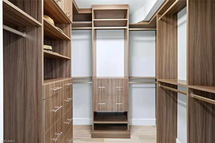 Custom shelving in the walk-in closet. Auto lights as you walk in.