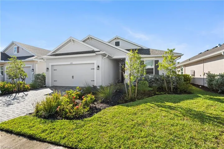 Charming Sweetwater model with beautiful curb appeal, a welcoming covered entry, and lush professiinaly landscaped yard.