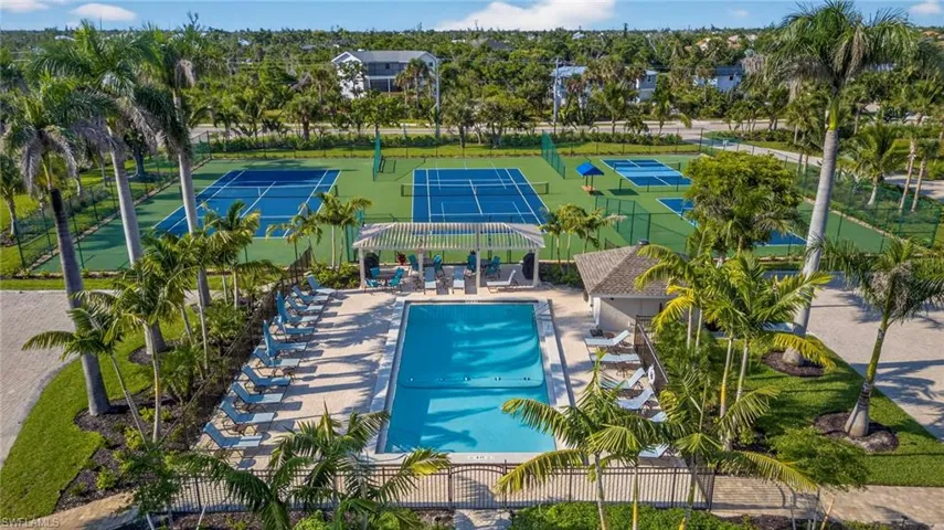 Aerial view of a pool area and a tree filled landscape