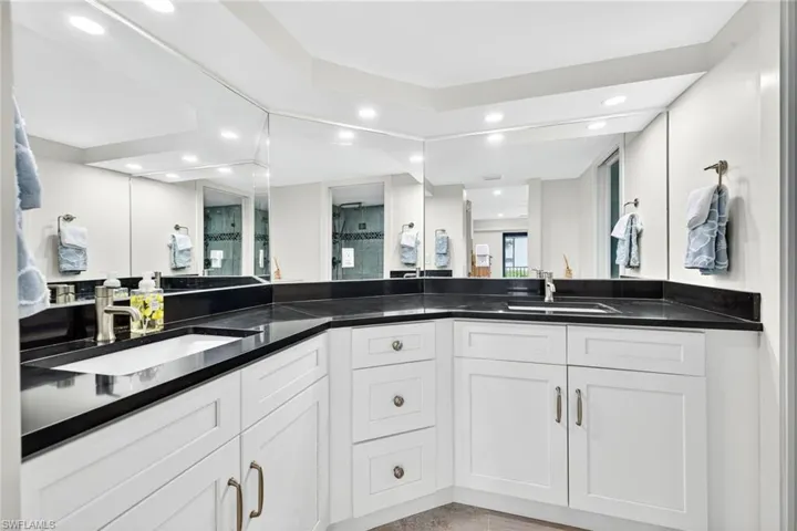 Full bathroom featuring double vanity and recessed lighting