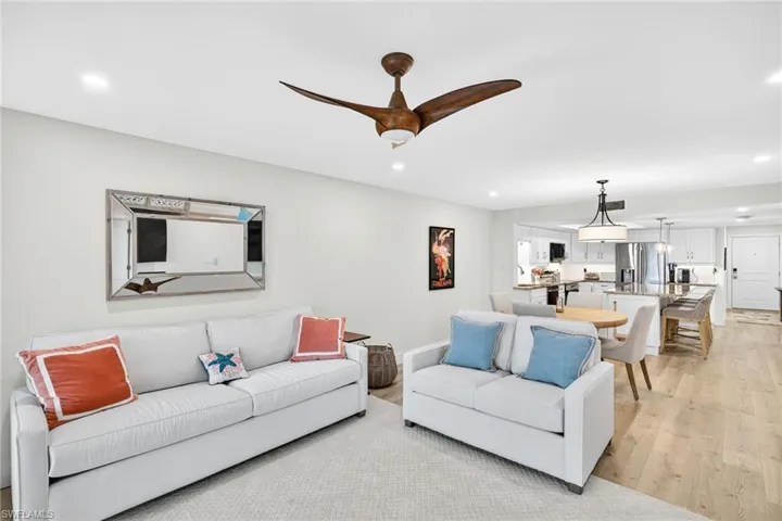 Living room featuring recessed lighting, light wood finished floors, and ceiling fan