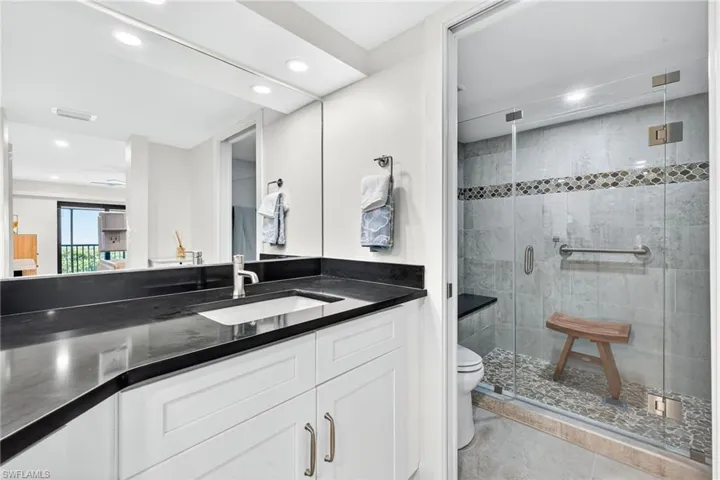 Full bath featuring vanity, a shower stall, light tile patterned floors, and recessed lighting