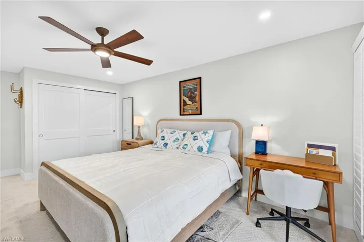 Carpeted bedroom with a closet, a ceiling fan, and recessed lighting