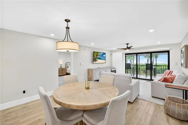 Dining room with light wood-style floors, recessed lighting, and ceiling fan