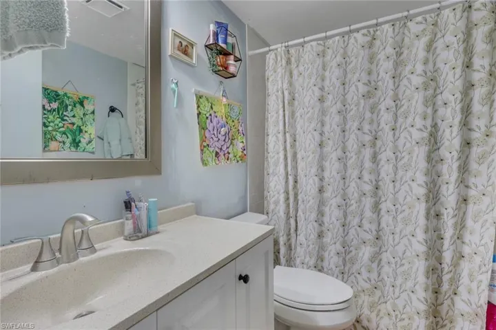 Full bathroom with vanity and a shower with curtain