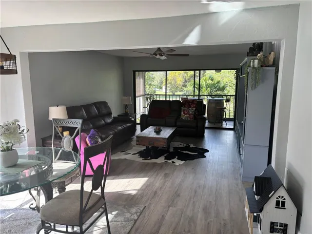 Living area featuring wood finished floors and a ceiling fan