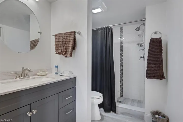 Full bath featuring vanity and a shower stall