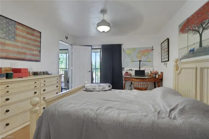 Bedroom with access to outside and wood finished floors