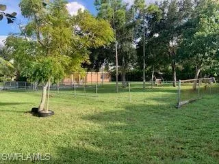 View of property's community with a yard